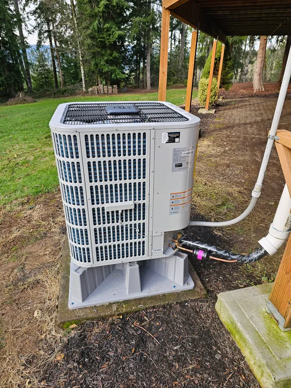 Bosch heat pump outdoor unit installed under a pergola at a Longview-area home